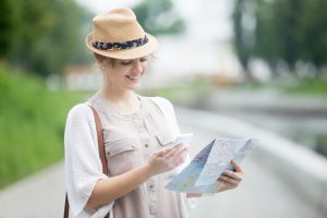 A women discovering Smart Destinations in the map to visit them and has a great tourist experience